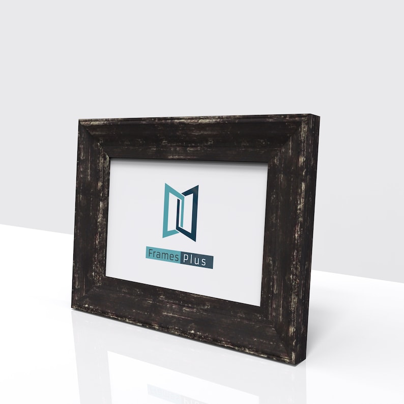 May include: A black wooden picture frame with a distressed finish. The frame has a white mount and a clear glass front. The frame is displaying a logo for Frames Plus.