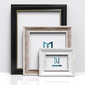 May include: Three picture frames of different sizes and colours. The largest frame is black with a gold trim. The middle frame is a light wood colour with a distressed finish. The smallest frame is white with a distressed finish. The frames are all empty.