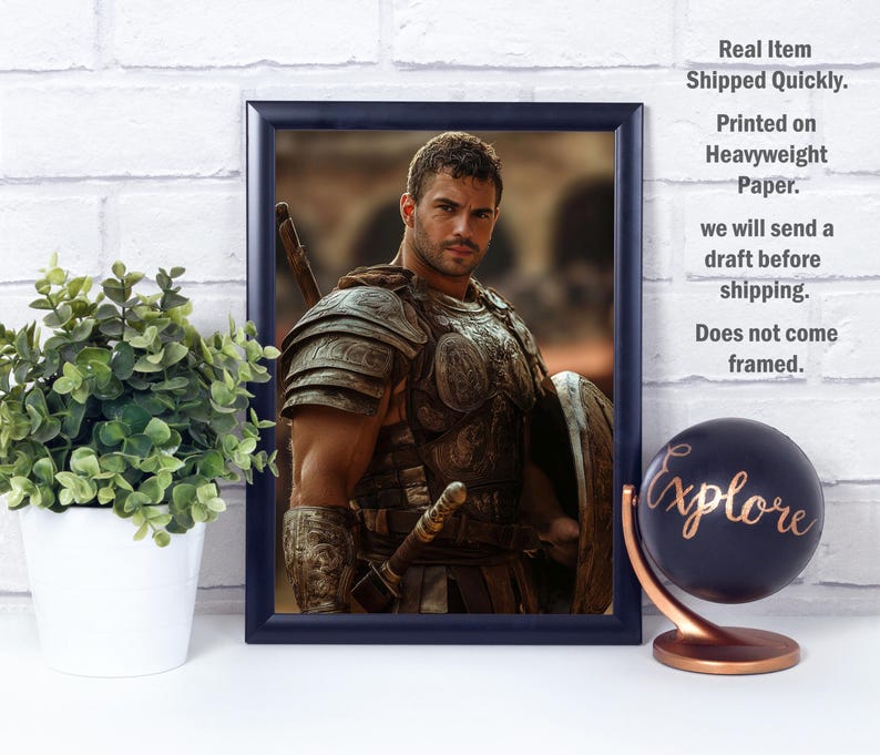 May include: Framed print of a man in ancient armor, holding a sword and shield. The image has a dark blue frame. A small potted plant and a globe with the word "Explore" are in the foreground.