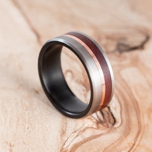 Fire-blackened titanium ring with copper and Mopane liner. Wedding ring, engagement ring.