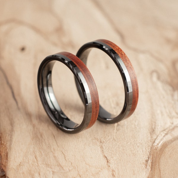 Pair of ceramic titanium and Mopane wood wedding rings. Wedding ring, engagement ring.
