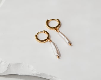 Elongated Pearl Huggie Earring | gold hoop cuff earring featuring a long delicate pearl pendant