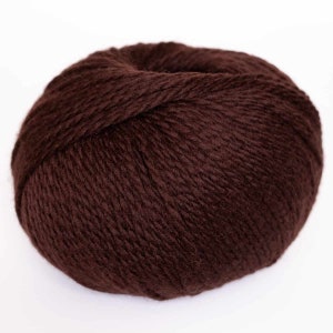 May include: A ball of dark brown yarn.