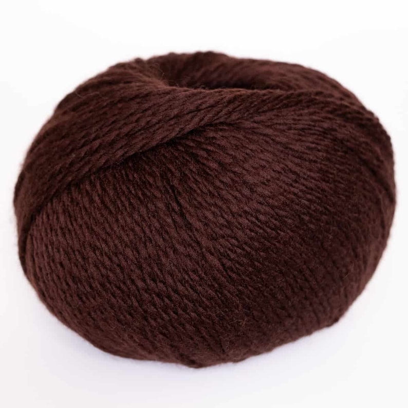 May include: A ball of dark brown yarn.