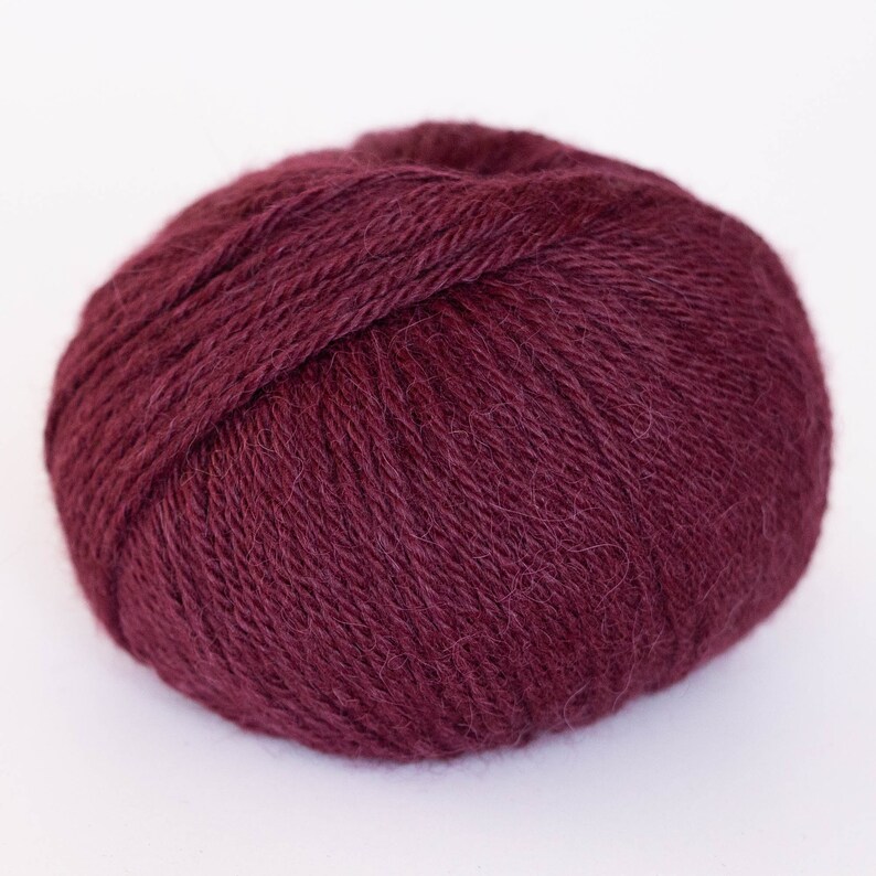 May include: A ball of deep burgundy yarn, perfect for knitting or crocheting.