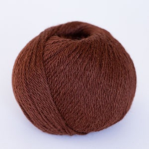 May include: A ball of brown yarn, perfect for knitting or crocheting.