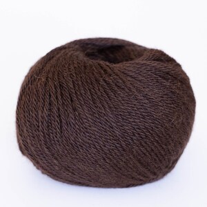 May include: A ball of dark brown yarn.