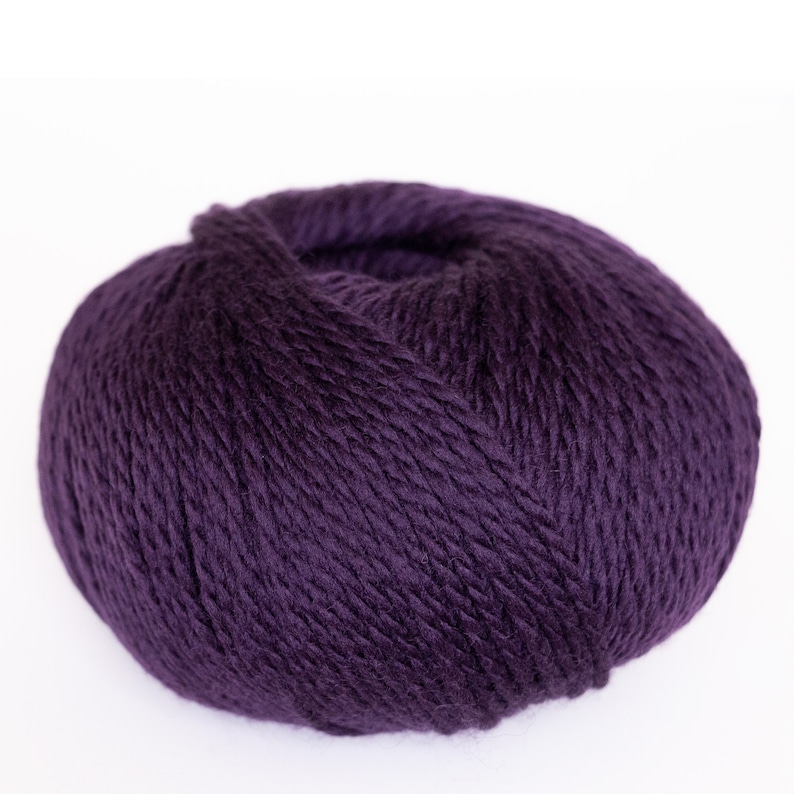 May include: A ball of deep purple yarn.