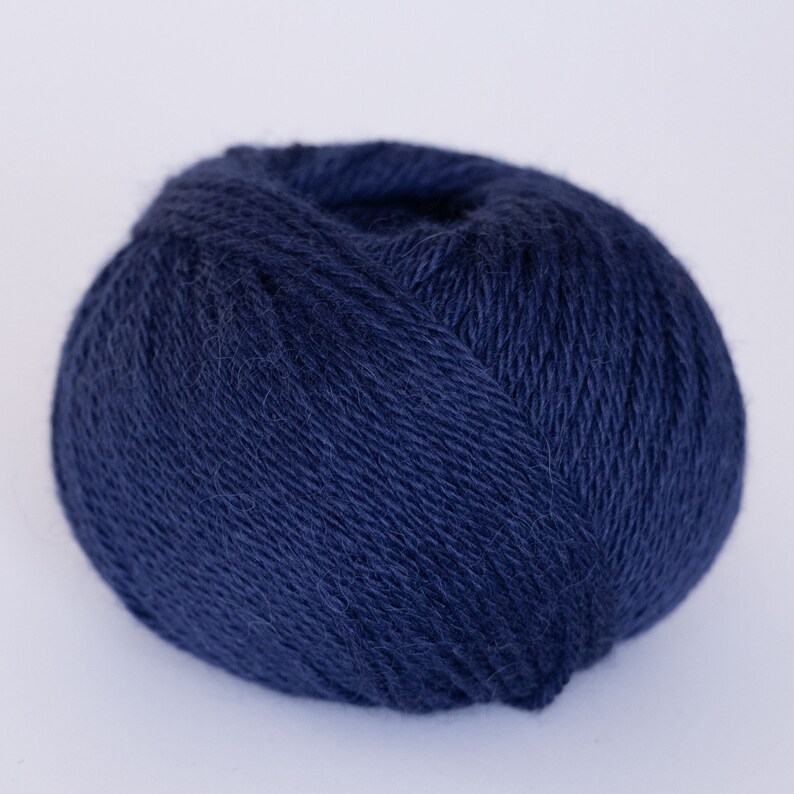 May include: A ball of dark blue yarn.