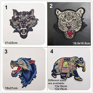 May include: Four embroidered iron-on patches featuring a wolf, a leopard, a wolf, and an elephant. The patches are available in different sizes. The wolf patches are 21x22cm and 19x21cm. The leopard patch is 10.5x10.5cm. The elephant patch is available in 13x10cm and 12x19cm.