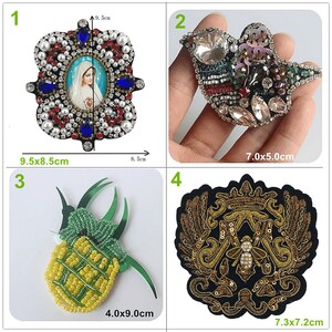 Peut inclure: Quatre patchs brodés différents avec des motifs variés. Le premier patch est une image religieuse de la Vierge Marie avec un fond bleu et des embellissements rouge, blanc et bleu. Le deuxième patch est un oiseau avec un centre en cristal clair et des embellissements colorés. Le troisième patch est un ananas avec des perles jaunes et vertes. Le quatrième patch est un motif or et noir avec une abeille au centre.