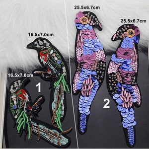 May include: Three embroidered bird appliques with sequins and beads. The birds are in shades of pink, blue, and green. The appliques are 16.5 x 7.0 cm and 25.5 x 6.7 cm.