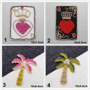 May include: Four beaded iron-on patches. Two patches are of the Queen of Hearts playing card, one with a white background and one with a black background. Two patches are of palm trees, one with pink leaves and one with green leaves.