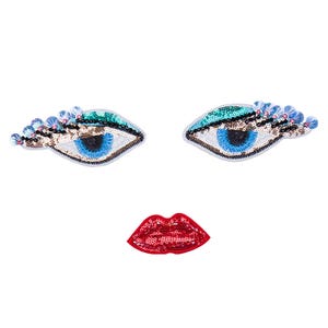 May include: Three embroidered patches: two blue eyes with sequins and a red lip with sequins.