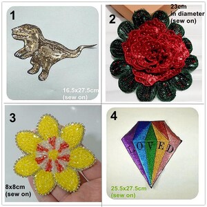 May include: Four iron-on patches for clothing or accessories. A gold dinosaur, a red rose, a yellow flower, and a rainbow diamond with the word "LOVED" in white.