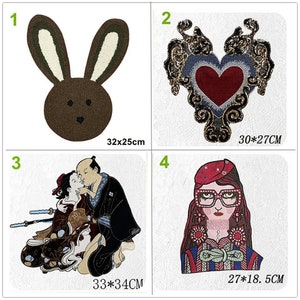May include: Four iron-on patches for clothing or fabric crafts. The patches are a brown bunny, a red heart with gold embellishments, a couple in traditional Japanese clothing, and a woman with glasses and a red hat. The patches are approximately 32x25cm, 30x27cm, 33x34cm, and 27x18.5cm.
