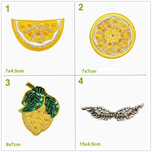 May include: Four embroidered patches: a lemon slice, a lemon wheel, a lemon with leaves, and a decorative wing design. The lemon slice measures 7x4.5cm. The lemon wheel is 7x7cm. The lemon with leaves is 9x7cm. The wing design is 15x4.5cm.