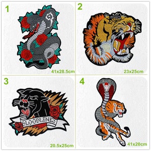 May include: Four embroidered iron-on patches featuring different animal designs. The patches are black, orange, and gray with red and white accents. The patches are approximately 41x28.5 cm, 23x25 cm, 20.5x25 cm, and 41x20 cm.