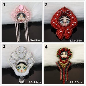 May include: Four beaded portrait brooches. 1: Pink with crystals, 9x4.3cm. 2: Red with crystals, 5.7x4.5cm. 3: White with pearls and crystals, 7.5x4.7cm. 4: Red, green, and gold with beads and crystals, 9.9x3.5cm. Each features a central face illustration.
