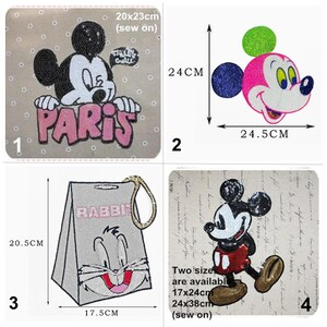 May include: Four iron-on patches featuring Mickey Mouse. The first patch shows Mickey Mouse peeking over the word "PARIS" in pink letters. The second patch shows Mickey Mouse's head with a pink face, blue ear, and green hat. The third patch shows a grey rabbit with a pink nose and the word "RABBIT" in white letters. The fourth patch shows Mickey Mouse walking with a red shirt and black shorts. All patches are made of sequins.