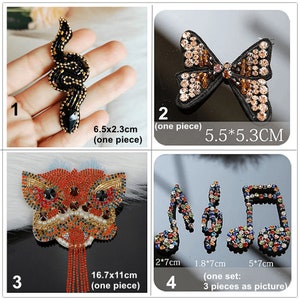 May include: Four sets of iron-on patches featuring various designs. The first patch is a black snake with gold accents, measuring 6.5 inches by 2.3 inches. The second patch is a brown butterfly bow measuring 5.5 cm by 5.3 cm. The third patch is a red and orange lion's head with gold accents and a beaded tassel, measuring 16.7 cm by 11 cm. The fourth set is three musical note patches in various colors, measuring 2 cm by 7 cm, 1.8 cm by 7 cm, and 5 cm by 7 cm.