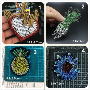 May include: Four embroidered iron-on patches with various designs. The first patch is a red, white and gold hand making a peace sign with a heart in the palm. The second patch is a green and black beaded design of a radish with rhinestones. The third patch is a yellow pineapple with green leaves and black beads. The fourth patch is a blue and brown flower with sequins.