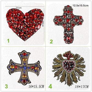 May include: Four iron-on patches with religious themes. The patches are decorated with rhinestones and beads. The patches include a red heart, a red cross, a blue and gold cross, and a gold heart with flames.