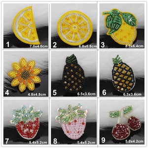 May include: Nine embroidered iron-on patches featuring various fruits and flowers. The patches are yellow, red, black, and pink. The patches are approximately 4 to 8 centimetres in size.
