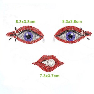May include: Three rhinestone-encrusted patches in the shape of eyes and lips. The eyes are red and blue with silver accents and measure 8.3 x 3.8 cm. The lips are red and measure 7.3 x 3.7 cm.