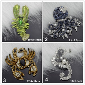May include: Four embroidered iron-on patches featuring sea creatures. The patches are 10.6x4.9cm, 9.4x9.0cm, 12.4x11cm, and 11x5.0cm. The patches feature a green lobster, a blue octopus, a gold crab, and a silver seahorse.