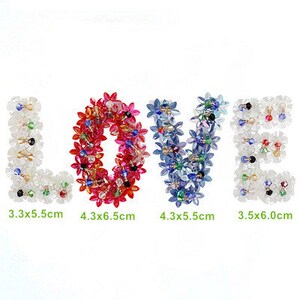 May include: The word "LOVE" spelled out using colourful crystal flower beads. The letters are approximately 3.3 x 5.5 cm, 4.3 x 6.5 cm, 4.3 x 5.5 cm, and 3.5 x 6.0 cm.