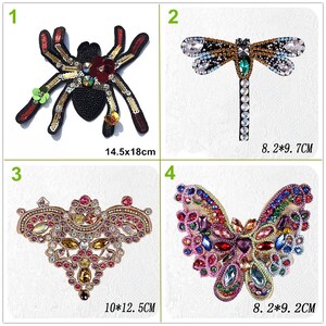 May include: Four embroidered iron-on patches featuring a spider, dragonfly, heart, and butterfly. The patches are decorated with colourful rhinestones and beads. The spider patch is 14.5 cm by 18 cm, the dragonfly patch is 8.2 cm by 9.7 cm, the heart patch is 10 cm by 12.5 cm, and the butterfly patch is 8.2 cm by 9.2 cm.