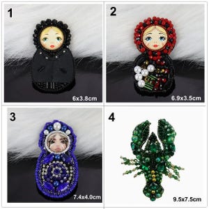 May include: Four beaded brooches are displayed. The brooches feature a black Matryoshka doll (6 x 3.8 cm), a red Matryoshka doll (6.9 x 3.5 cm), a blue Matryoshka doll (7.4 x 4.0 cm), and a green lobster (9.5 x 7.5 cm).