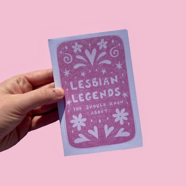 May include: A pink and white card with the text "LESBIAN LEGENDS" and "YOU SHOULD KNOW ABOUT" in a decorative font. The card features floral and star designs. The background is a solid pink color.