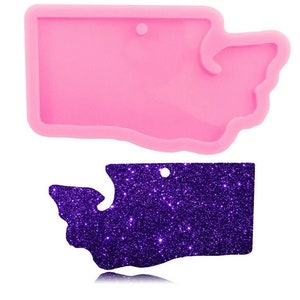 May include: A pink silicone mold shaped like the state of Washington. The mold is designed for making resin crafts.