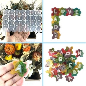 May include: A set of colorful alphabet puzzle pieces with glitter embedded in the resin. The pieces are shaped like puzzle pieces and have the letters of the alphabet on them. There is also a heart-shaped piece. The pieces are arranged in a variety of ways, including a word spelling "LOVE" and a pile of pieces.