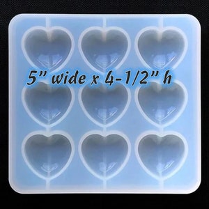 May include: A blue silicone mold with 8 heart-shaped cavities. The mold is 5 inches wide and 4-1/2 inches tall.