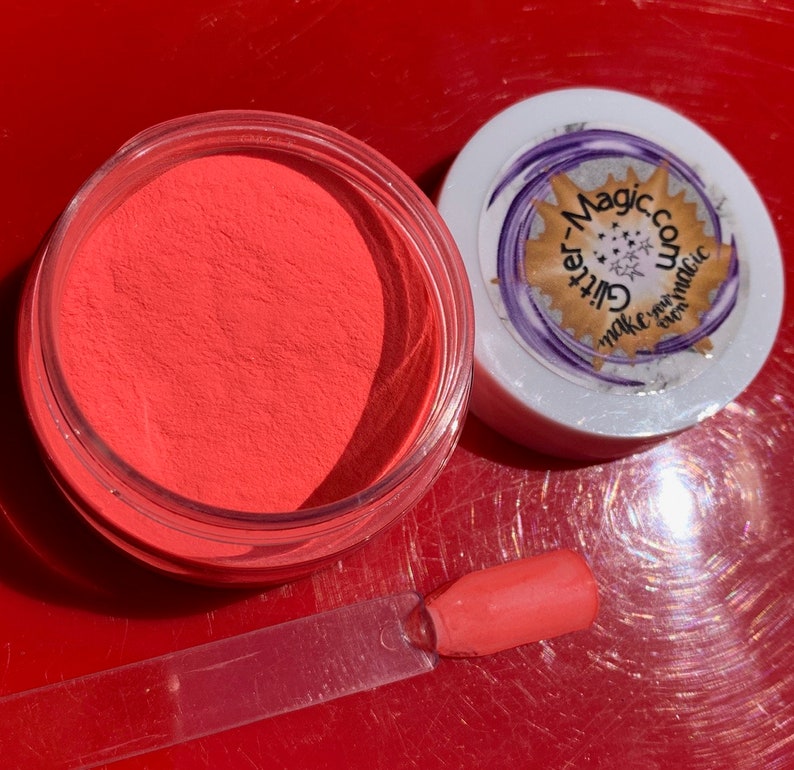 May include: A small jar of bright orange glitter powder with a clear lid. The jar is labeled "Glitter-Magic.com Make your magic even magic".