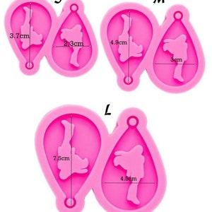 May include: Three pink silicone molds for making earrings. The molds are labeled S, M, and L, and the measurements of each mold are shown in centimeters.