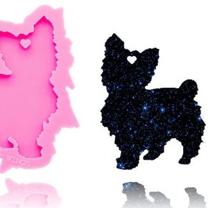 May include: Pink silicone mold of a Yorkshire Terrier dog with a heart cutout. The mold is used to create resin charms or ornaments.