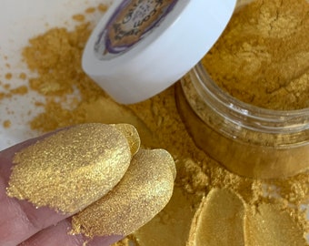 May include: A small jar of gold mica powder. The powder is a fine, shimmery gold color. The jar is labeled "Galaxy Eco-Glitter".