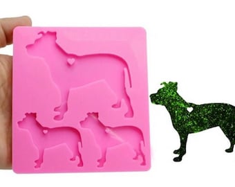 May include: Pink silicone mold with three dog silhouettes. The mold is designed to create resin dog charms with a heart detail.