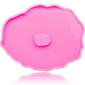 May include: Pink silicone mold shaped like an agate slice with a round hole in the center.