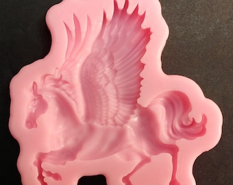 May include: Pink silicone mold for making a winged horse, or pegasus, cake topper or other decorative item.