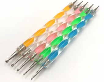 May include: Set of six colorful nail art tools with clear handles and silver metal tips. The handles have a spiral pattern with alternating colors of yellow, pink, green, and blue.
