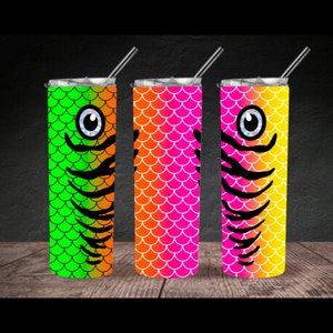 May include: Three stainless steel tumblers with a fish scale design. The tumblers are green, orange, and yellow with black stripes and a glittery eye.