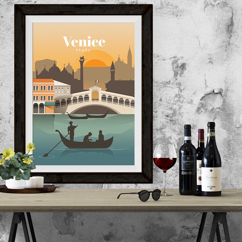 May include: A framed poster with a colorful illustration of Venice, Italy. The poster features a bridge, gondolas, and buildings. The text "Venice, Italy" is printed on the poster.