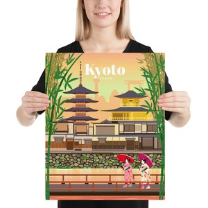 May include: A colorful illustration of a traditional Japanese temple in Kyoto, Japan. The temple is surrounded by bamboo and features a pagoda and a golden building. Two women in traditional kimonos and red umbrellas walk on a bridge in front of the temple.
