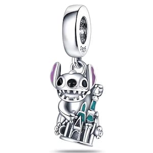 May include: A silver charm featuring a cartoon character with large ears and a wide grin, holding a castle. The charm has purple accents on the ears and a turquoise and green castle. The charm is marked with "S925".