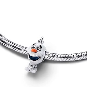 May include: A silver charm featuring the character Olaf from the movie Frozen. The charm has a white head with a carrot nose, black eyes, and a wide smile. The charm is attached to a silver snake chain bracelet.